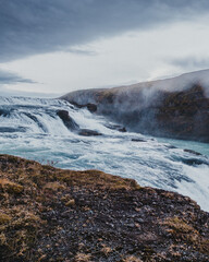 Fototapeta premium Side view of the cascading Gullfoss waterfall in south Iceland's rugged landscape...