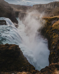 Breathtaking view of Gullfoss waterfall plunging into a deep canyon in south Iceland.