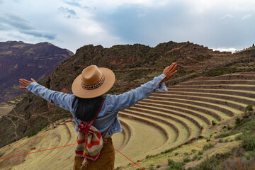 Latin tourist looking at the terraces of Pisac, Pisac archaeological complex in Cusco
