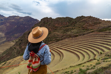 Latin tourist looking at the terraces of Pisac, Pisac archaeological complex in Cusco