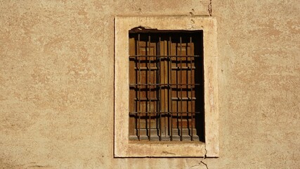window with lattice in rustic facade as background