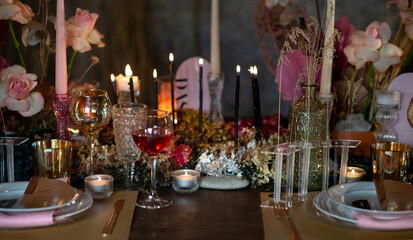 Wedding table decoration in red-pink and burgundy colors in bright lights