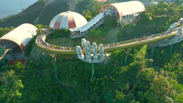 Aerial view of the Golden Bridge is lifted by two giant hands in the tourist resort on Ba Na Hill in Da Nang, Vietnam.