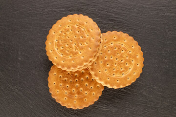 Chocolate cookies with homemade kitchen utensils, close-up, top view and isolated on white background.