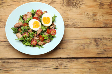 Delicious fresh tuna salad on wooden table, top view. Space for text
