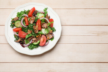 Delicious fresh tuna salad on wooden table, top view. Space for text