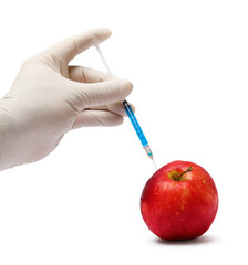 GMO concept. Scientist injecting something into fresh apple against white background, closeup