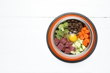 Dry pet food and natural products on white table, top view