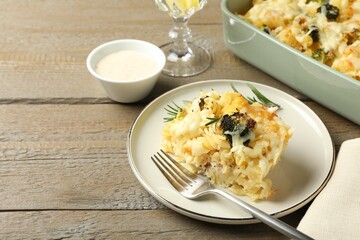 Tasty pasta casserole with cheese and broccoli served on wooden table, closeup. Space for text