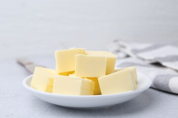 Pieces of fresh butter on white table, closeup