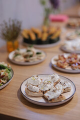 An inviting display of various gourmet dishes is set elegantly on a wooden table, featuring creamy...