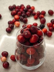 Vibrant assortment of fresh cherries arranged artistically in a glass on a marble surface during golden hour