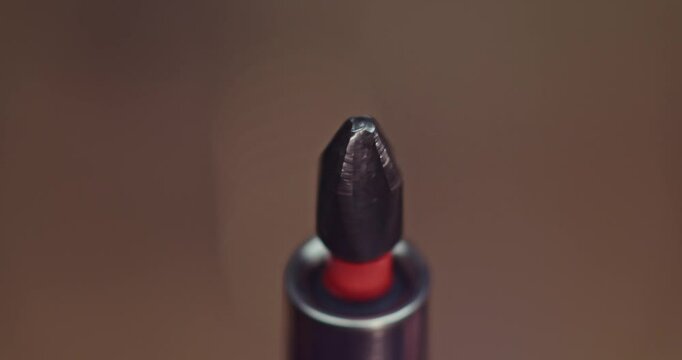 This image captures a detailed closeup shot of a screwdriver tip featuring a striking red accent PH2
