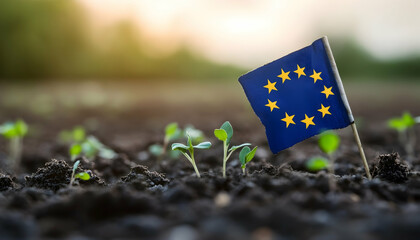 European Union flag amidst young green sprouts in a field, representing sustainability and growth -