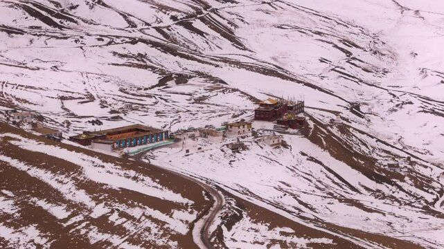 A panoramic view of Komic village in Spiti Valley, showcasing snow-blanketed landscapes