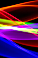Neon Rainbow Light on Black Background Abstract Lines Swirls and Waves