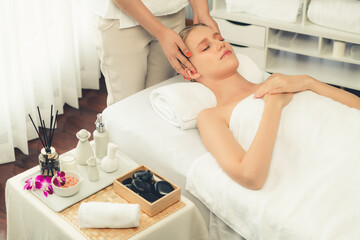 Caucasian woman enjoying relaxing anti-stress head massage and pampering facial beauty skin...