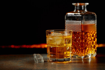 Whiskey with ice on a black background.