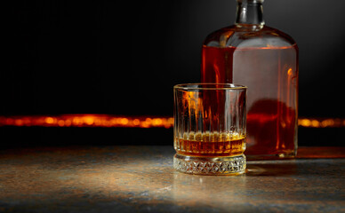 Whiskey with ice on a dark background.