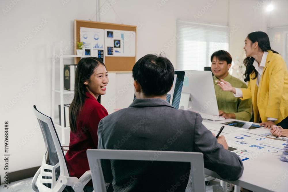 Poster Group of young asian businesspeople working together in modern office, discussing and analyzing financial charts and graphs using desktop computer while preparing presentation for clients