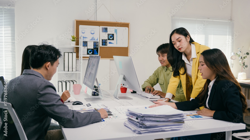 Poster group of young asian businesspeople working together, analyzing financial data on computer and docum