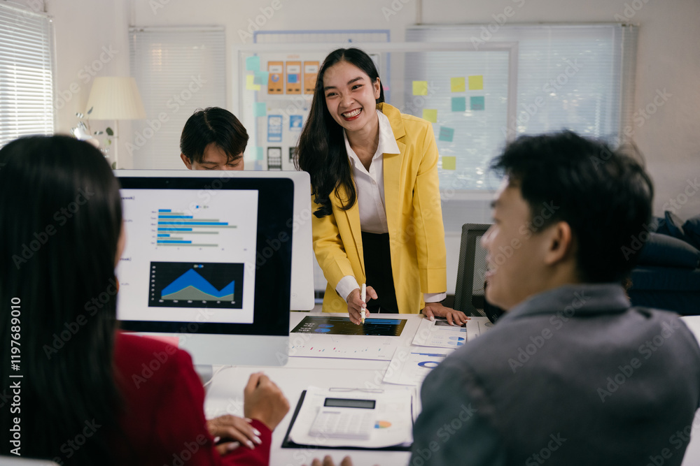 Poster young businesswoman leading a meeting with her team, discussing charts and statistics on a computer 