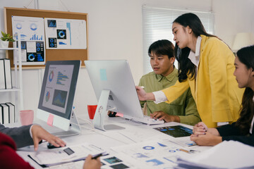 Fototapeta premium Business team working together, analyzing charts and graphs on computer screen, discussing financial data and statistics in office meeting, collaborating on project strategy and planning