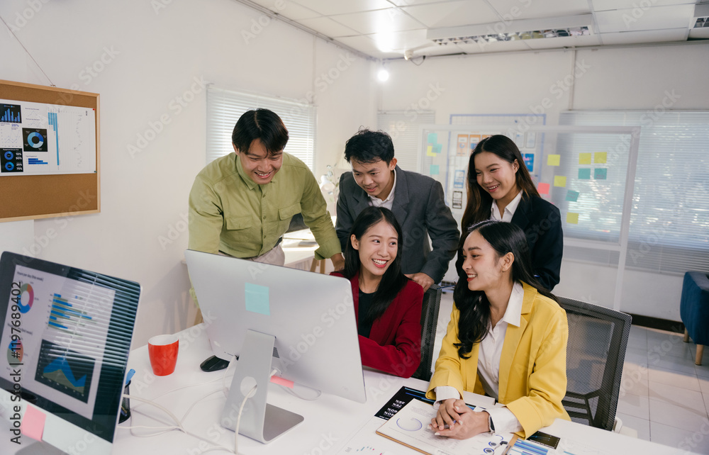 Poster five asian businesspeople collaborating on a project, gathering around a computer in a modern office