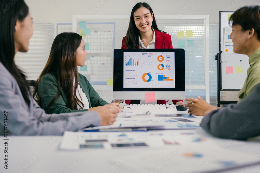 Poster young asian businesswoman leading a meeting in a modern office, using a computer to display charts a