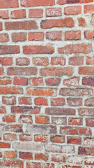 The red brick walls are brittle with age