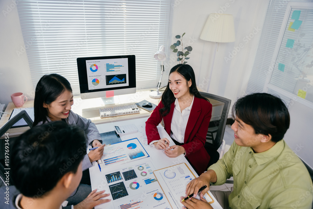 Poster four asian entrepreneurs are discussing company performance, analyzing charts and graphs, working to