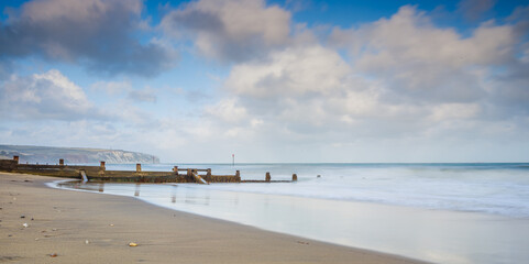 seascape of beach and sea with groynes on long exposure