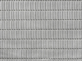 Close up photo of beautiful white woven fabric texture. Synthetic fabric art resembling subway tiles in white color. Repeated stripes shapes. Seamless background texture.