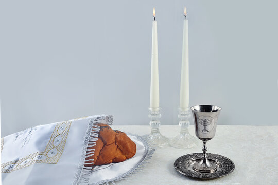 Sabbath Table Setting. Challah bread, candles, and a kiddush cup