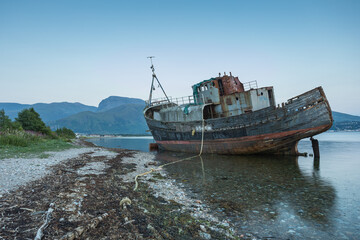 shipwrecked boat in bay