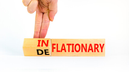 Deflationary or inflationary symbol. Concept words Deflationary Inflationary on wooden blocks. Beautiful white background. Businessman hand. Business deflationary inflationary concept. Copy space