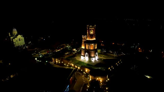 4K Aerial drone video of Gardos Tower in Zemun, Belgrade, Serbia on a clear winter night. Wonderful monument from Austro-Hungarian era standing out lit in the dark