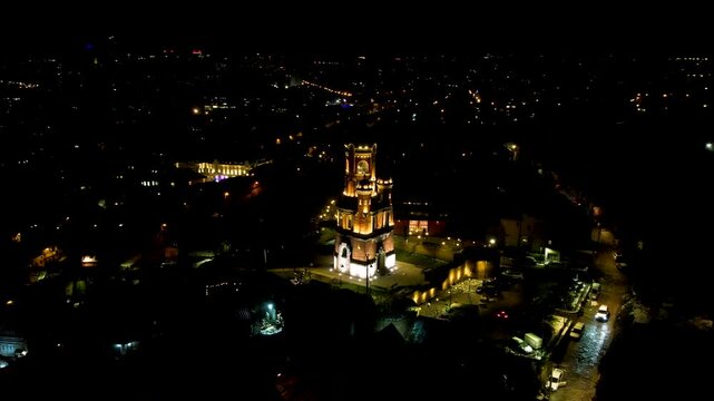 4K Aerial drone video of Gardos Tower in Zemun, Belgrade, Serbia on a clear winter night. Wonderful monument from Austro-Hungarian era standing out lit in the dark