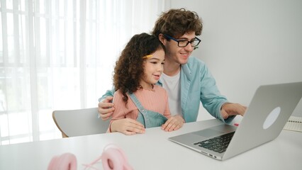 Father explain generate AI while american girl looking at screen. Attractive caucasian dad teaching...