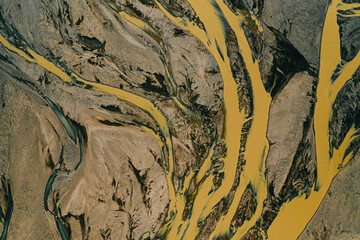 Naklejka premium Aerial view of vibrant braided glacial rivers winding through Jokulsasandur, Lon, east Iceland...