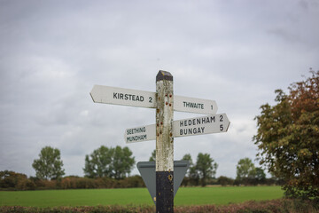 street sign with directions and miles