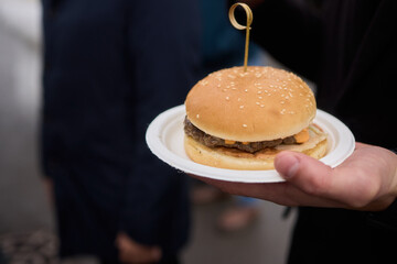 A Delicious Hamburger Served on a Plate, Perfectly Placed in My Hand for Enjoyment