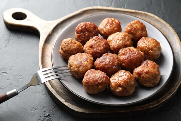Tasty cooked meatballs served on grey table, closeup