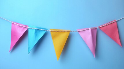 Colorful paper bunting, hanging, blue background, celebration.