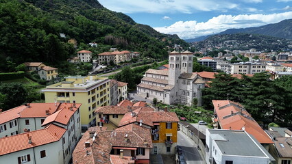 bird aerial view of Sant'Abbondio cathedral in Como Romanesque-style time with old city and lake in backbround