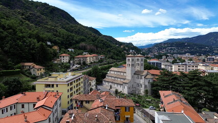 bird aerial view of Sant'Abbondio cathedral in Como Romanesque-style time with old city and lake in backbround