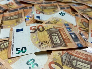 Euro banknotes background close up, fifty euro cash pile	