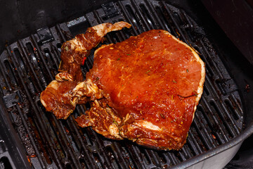 Pork steak is cooked in an air grill