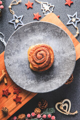 Cinnamon Rolls brioches or cinnamon rolls with icing sugar and cream cheese - decorated for Christmas