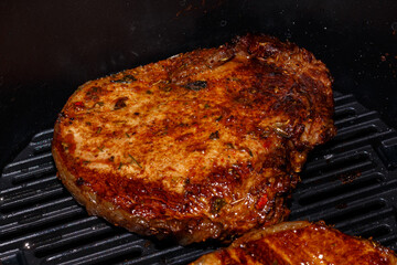 Pork steak is cooked in an air grill